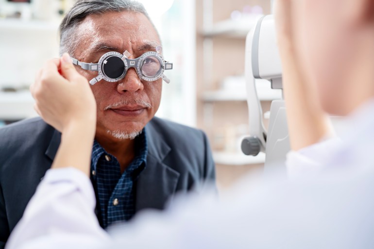 Improving Eyesight and Identifying Potental Health Isues a comprehensive Eye Exam for Old Adults. A Senior Male During Eye Exam with Optometrist by Diopter Tool An Ophthalmology Clinic.