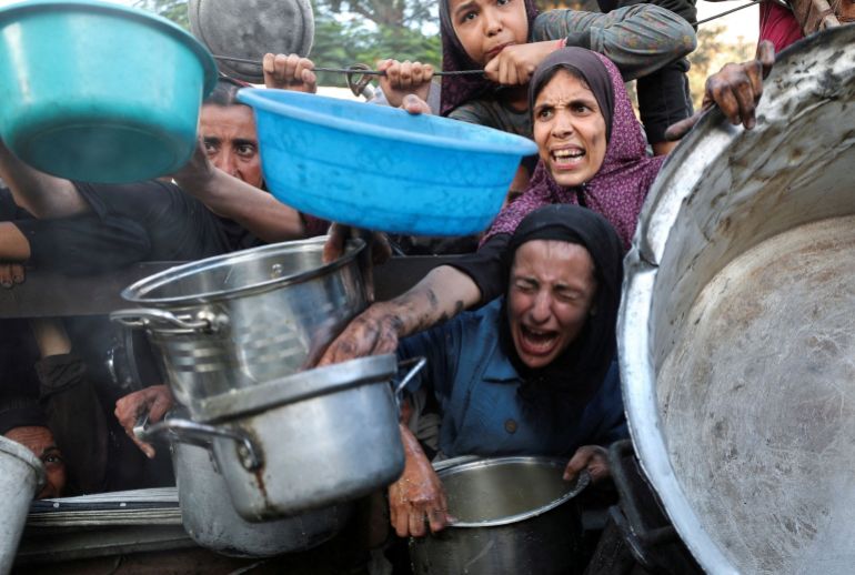File Photo: palestinians wait to recough food from a crechen, Amid a hunger Crisis, in Gaza City File Photo: Palestinians React as they Ask for Food from A Charity Kitchen, Amid A Hunger Crisis, in Gaza City, July 14, 2025.