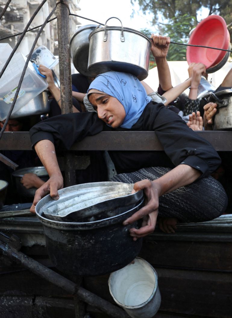 A palestinian Woman Reacts Asks for Food from a Charity Kitchen, Amid A Hunger Crisis, in Gaza City, July 14, 2025. Reuters/Mahmoud Issa