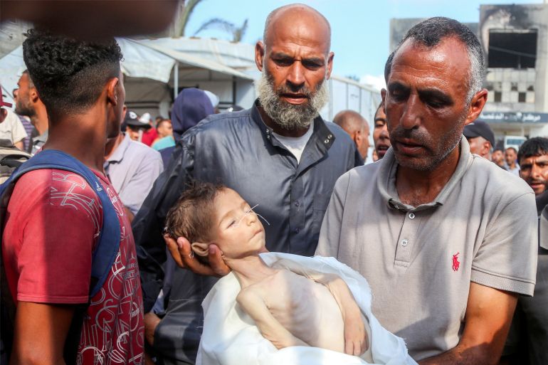 Edits Note: Graphic Content / Topshot - The Father of Yahya Fadi Al -Najjar, An Infant Who Died to Malnourishment, Holds His Body During the Funeral at Nasser Medical Complex in Khan Yunis in The South Hard Gaza Strip on July 20, 2025.