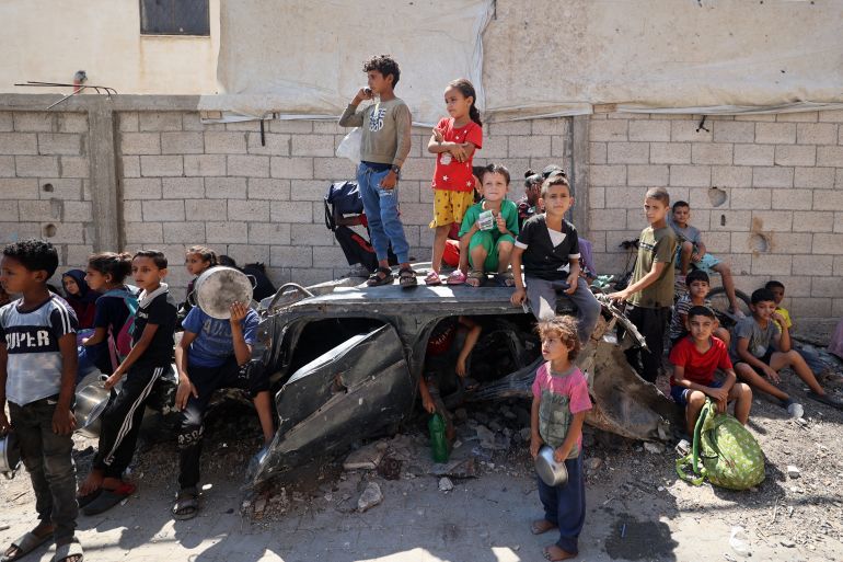 Palestinians children wait at a Food Distribution Point in the Nuseirat Refgee Camp in the Central Gaza Strip on JULY 19, 2025.