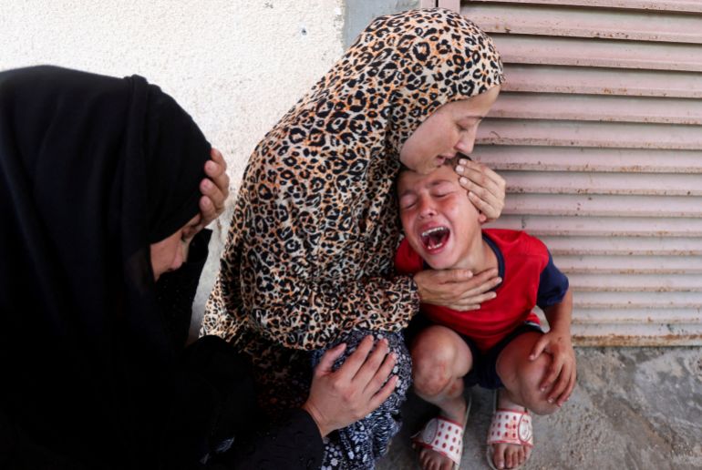 Plestinian Mother Samah Al-Nouri, Whose Daughter Sama Was Killed in an ISRAELI Strike on Thursday Near a Medical Center in Deir Al-Balah, Comforts Her Son, as Casualts from the Strike Are BROGHT INTO Al-Aqsa Martyrs Hospital, in Deir Al-Balah, Center GAZA Strip, July 10, 2025. Reuters/Ramadan Abed Tpx Images of the day