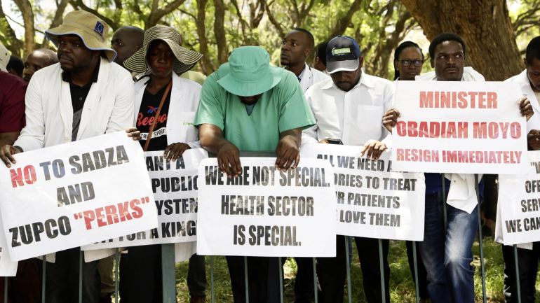 Zimbabwe's Senior Doctors Hold Placards During A Protest in harar List of demands before them Stop them Strike. Zimbabwe's Doment Been on Strike For More Three Months Over Salry Increase and Better Working Conditions. EPA-Enfe/Aaron Ufumeli
