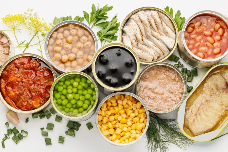 An assortment of processed food with long shelf life, canned fish and vegetables.