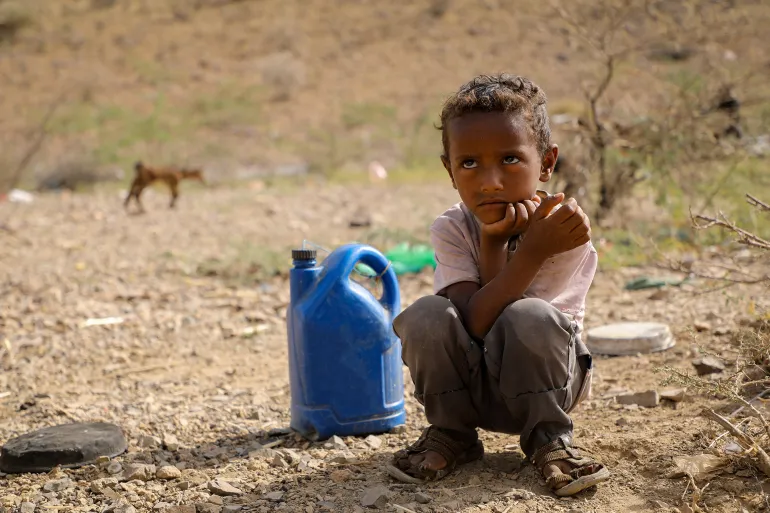 Taiz Yemen - 18 Feb 2022: A sad child searches for water in the camps for the displaced from the war in the city of Taiz, Yemen; Shutterstock ID 2465233049; purchase_order: aj; job: ; client: ; other: