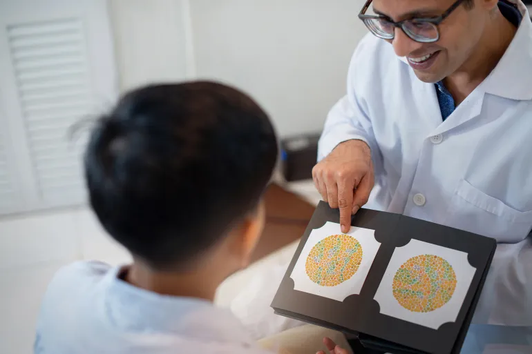 Indian optometrist or optician get color blindness tested for indian child boy, vision and eye care concept by chomplearn_2001 @Adobe Stock
