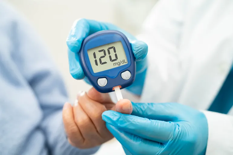 Diabetes - Doctor use digital glucose monitor measure and test stripe to check diabetes from finger blood sugar level.
