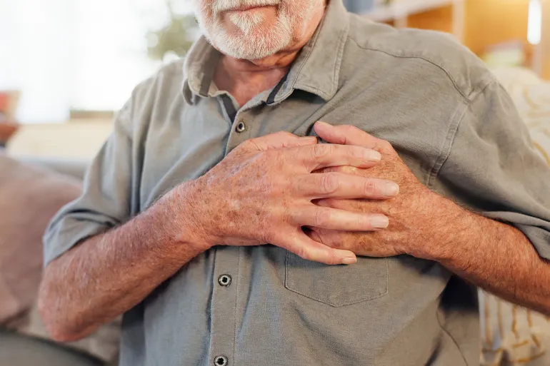 Old man, home and hands on chest for heart attack, pain and hypertension, stress or lung failure. Elderly person, medical issue and heart disease or artery pressure, asthma and cardiac arrest; Shutterstock ID 2486702355; purchase_order: aj; job: ; client: ; other: