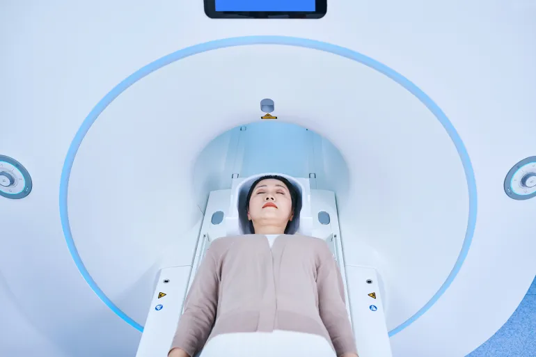 Aerial view of one Asian female patient receiving MRI scan.