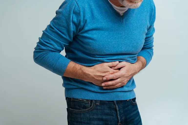 Handsome senior isolated on gray background. Old man feeling pain. Concept about the third age and seniority; Shutterstock ID 1988521742; purchase_order: aj; job: ; client: ; other: