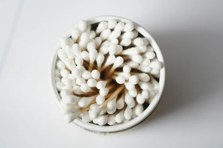 Top view of cotton buds stacked in a container, emphasizing hygiene and healthcare.