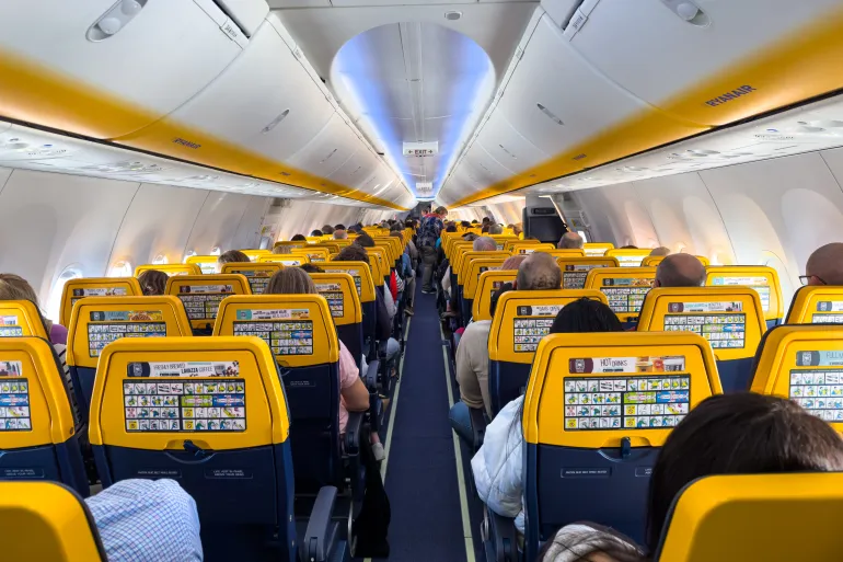 England - March 09, 2024; Passengers seated inside an airborne Ryanair 8200 plane