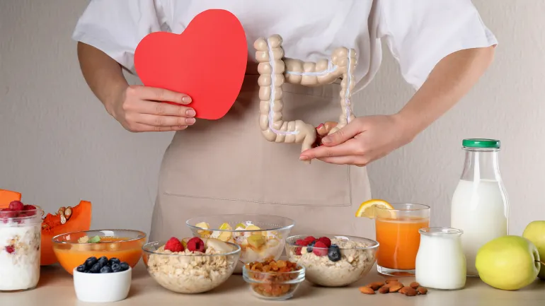 Video cover: A healthy lifestyle reduces the risk of intestinal inflammation. Woman holding paper heart and large intestine model near table with food, closeup. Balanced nutrition for healthy digestive system shutterstock_2131991277
