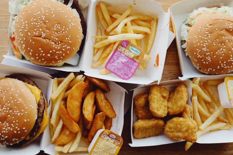 Top view of an assorted fast food meal including burgers, fries, and nuggets.
