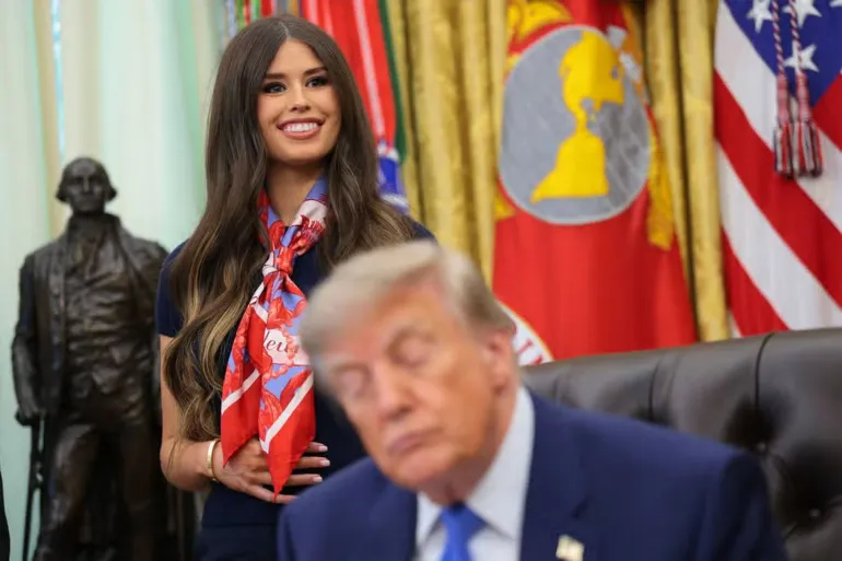 WASHINGTON, DC - AUGUST 10: Jayme Leagh Franklin with The Conservateur (L), stands behind US President Donald Trump (R), before he signs an executive order calling for childhood vaccine shots to be spaced out into separate visits during an event in the Oval Office of the White House on August 10, 2026 in Washington, DC. During his second term, Trump has urged Health and Human Services Secretary Robert F. Kennedy Jr. to investigate further research on vaccines. (Photo by Anna Moneymaker/Getty Images)