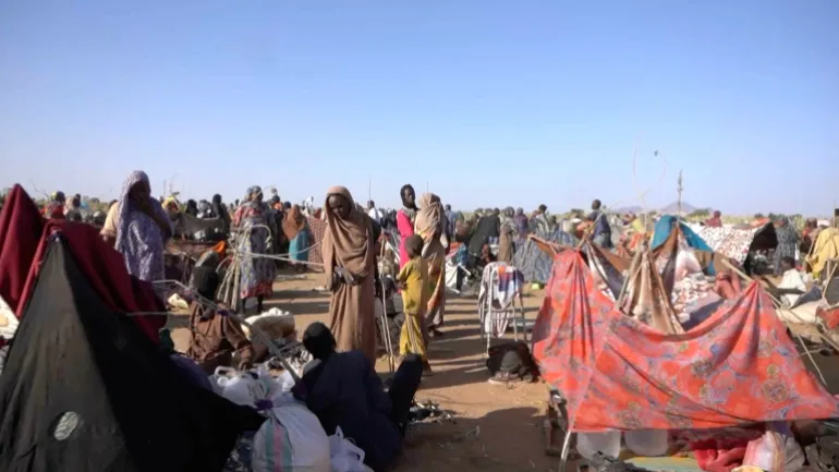 Displaced people who fled the city of El Fasher sit inside makeshift tents in the town of Tawila in the Darfur region, Sudan