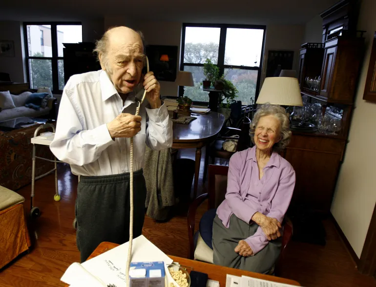 Leonid Hurwicz speaks on the phone with his brother as his wife, Evelyn, listens after they received news that he had won the Nobel Prize in Economics in Minneapolis, October 15, 2007. REUTERS/Eric Miller (UNITED STATES)